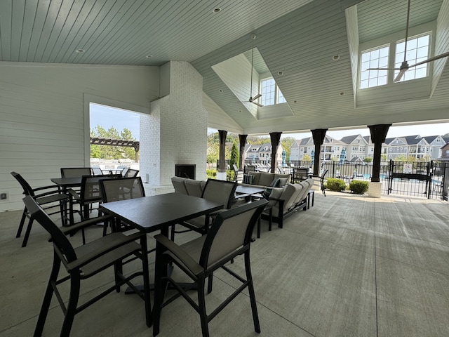 dining room featuring wooden ceiling, a fireplace, high vaulted ceiling, and plenty of natural light