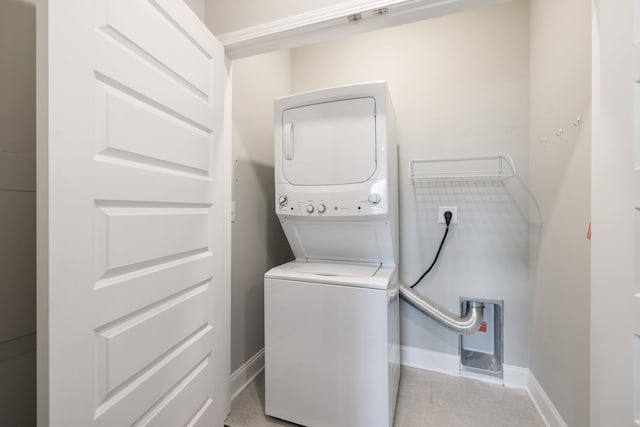 laundry area featuring stacked washer / dryer