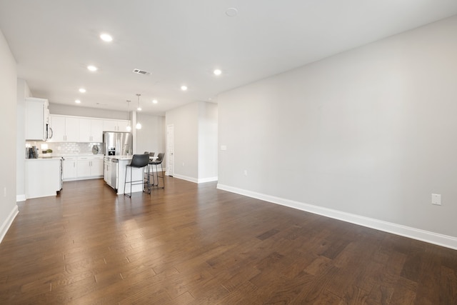 unfurnished living room with dark wood-type flooring