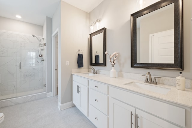 bathroom with a shower with door and vanity