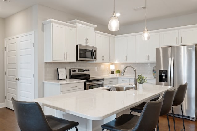 kitchen featuring appliances with stainless steel finishes, white cabinets, sink, and dark hardwood / wood-style flooring