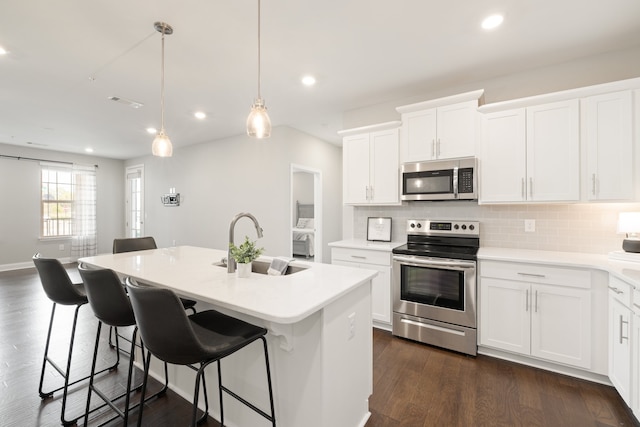 kitchen featuring an island with sink, white cabinets, and appliances with stainless steel finishes