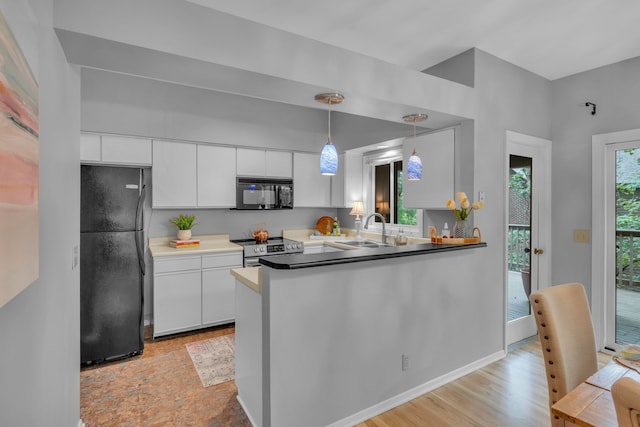 kitchen featuring light wood-type flooring, sink, white cabinets, black appliances, and decorative light fixtures