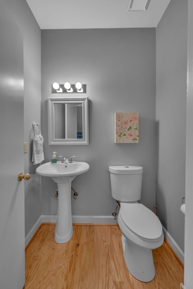 bathroom featuring hardwood / wood-style floors and toilet