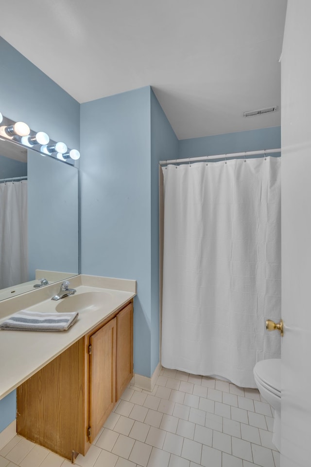 bathroom with tile patterned floors, vanity, and toilet