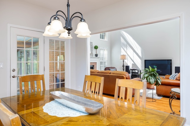 dining space featuring hardwood / wood-style flooring and a chandelier