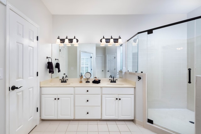 bathroom with walk in shower, vanity, and tile patterned flooring