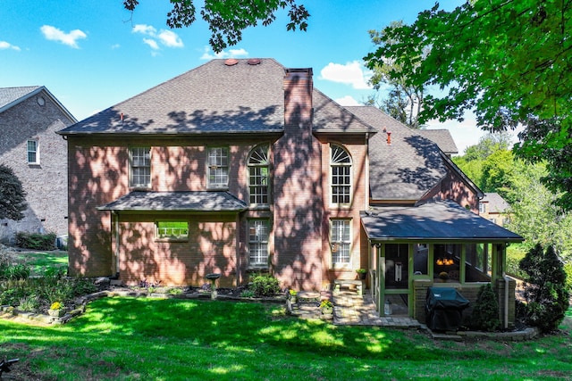 back of property featuring a lawn and a patio area