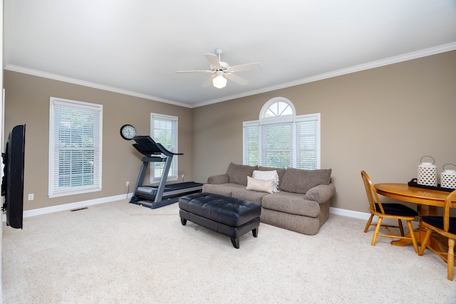 living room featuring light carpet, ceiling fan, and ornamental molding