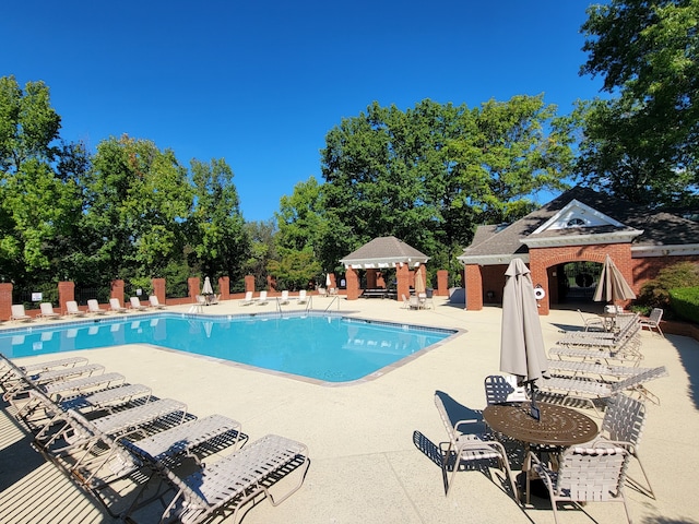 view of swimming pool with a patio and a gazebo