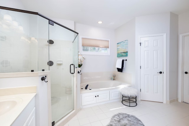 bathroom with tile patterned flooring, vanity, and separate shower and tub