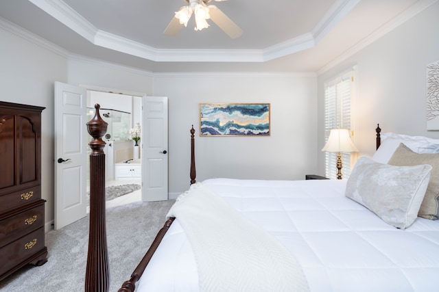 carpeted bedroom featuring ceiling fan, a raised ceiling, and crown molding