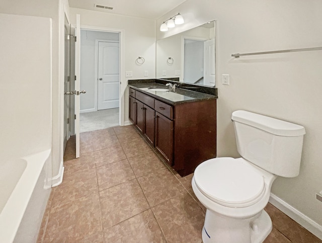 bathroom featuring vanity, toilet, and tile patterned floors