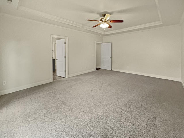 unfurnished room featuring carpet floors, ornamental molding, a tray ceiling, and ceiling fan