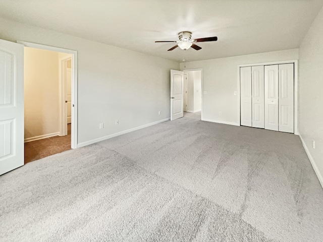 unfurnished bedroom with ceiling fan, a closet, and carpet