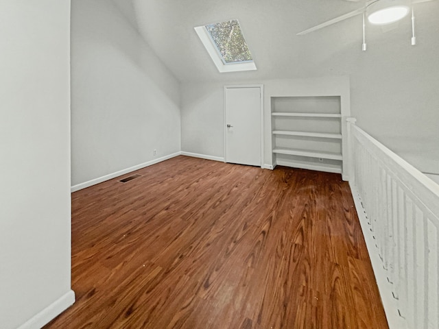 bonus room with a skylight and hardwood / wood-style flooring