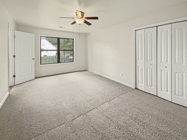 unfurnished bedroom featuring ceiling fan and carpet flooring