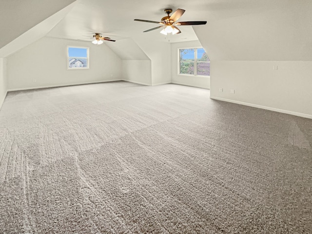 additional living space with ceiling fan, carpet floors, and vaulted ceiling