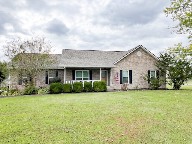 single story home with covered porch and a front yard