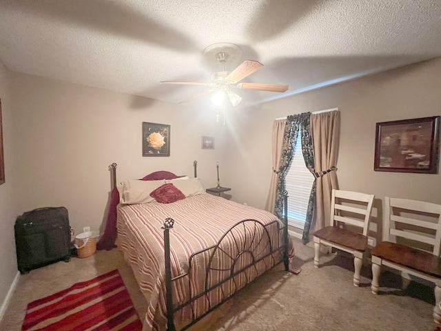 carpeted bedroom featuring ceiling fan and a textured ceiling