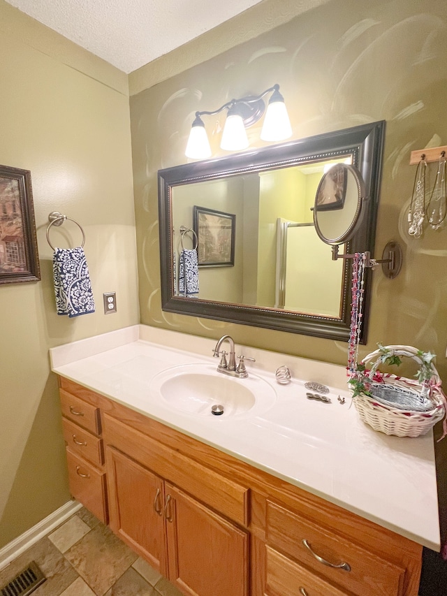 bathroom with vanity and a textured ceiling