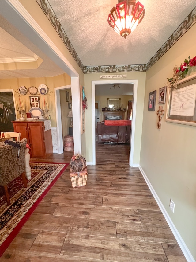 corridor featuring a textured ceiling and hardwood / wood-style flooring