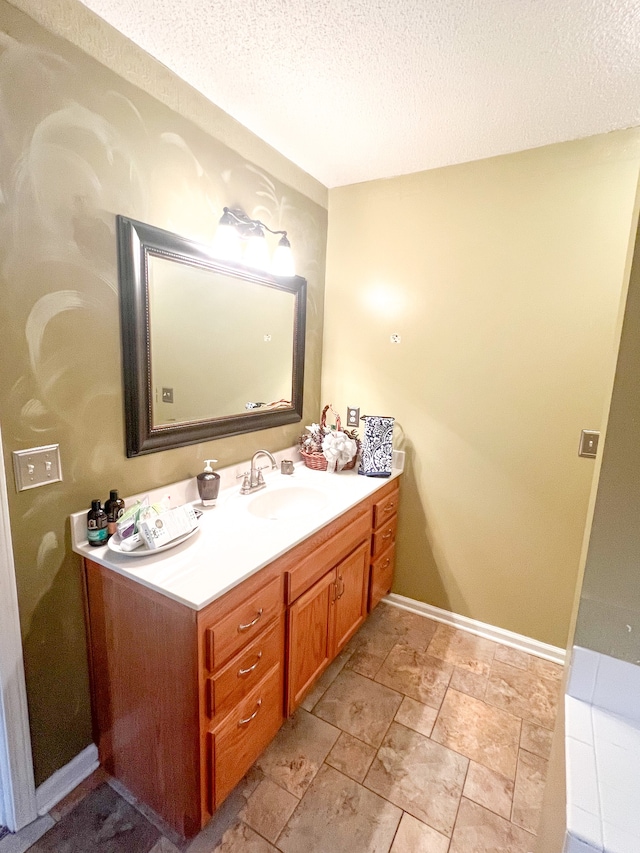 bathroom featuring vanity and a textured ceiling