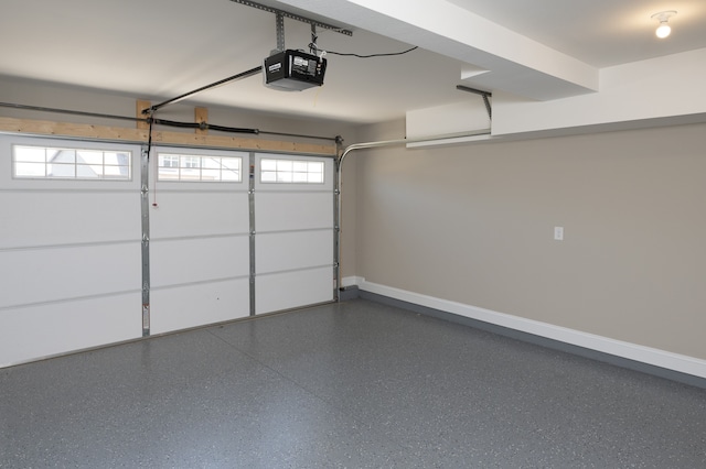 garage featuring a garage door opener and baseboards