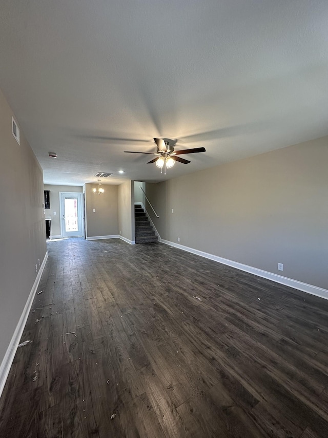 unfurnished living room with dark wood-type flooring and ceiling fan