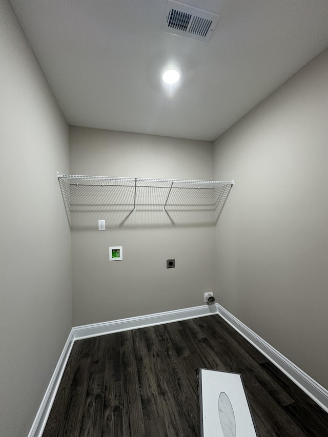 washroom with laundry area, visible vents, dark wood finished floors, and baseboards