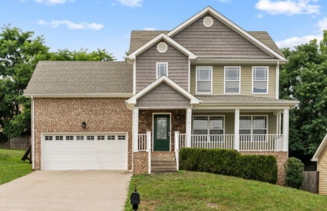 craftsman-style home featuring covered porch, a front yard, and a garage