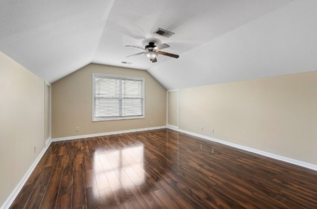 additional living space featuring lofted ceiling, ceiling fan, and dark hardwood / wood-style flooring