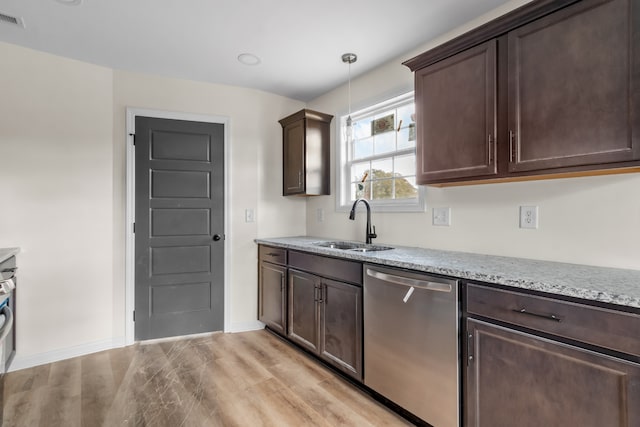 kitchen with hanging light fixtures, sink, stainless steel dishwasher, dark brown cabinets, and light hardwood / wood-style flooring