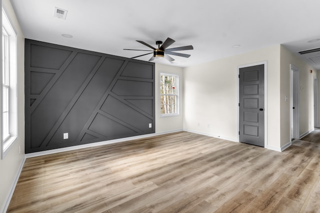 unfurnished room with light wood-type flooring and ceiling fan