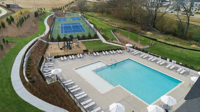 view of pool featuring a lawn, tennis court, and a patio area