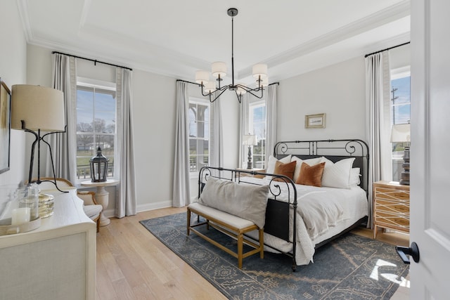 bedroom featuring a chandelier, multiple windows, and hardwood / wood-style flooring