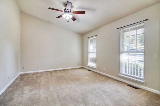 carpeted empty room with a textured ceiling and ceiling fan