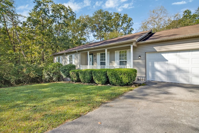 view of side of property with a garage, a porch, and a lawn