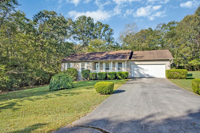 ranch-style house featuring a front lawn and a garage