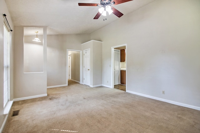 unfurnished bedroom featuring carpet flooring, ceiling fan, and ensuite bathroom