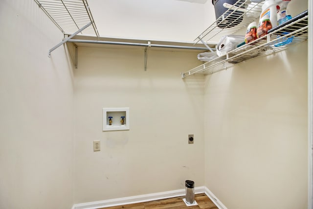 laundry area with hardwood / wood-style floors, hookup for a washing machine, and hookup for an electric dryer