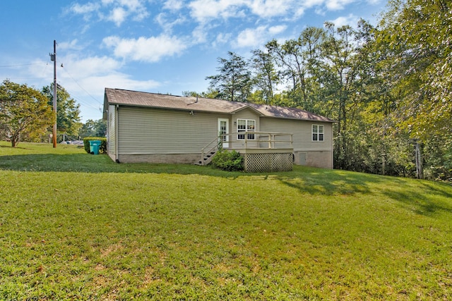 back of property with a lawn and a deck