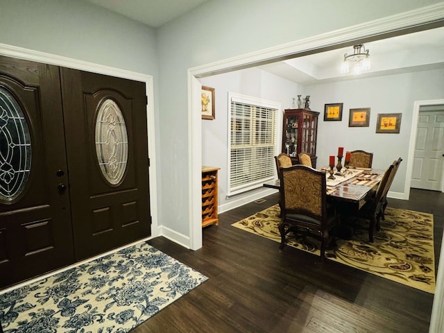 foyer entrance with a chandelier and dark hardwood / wood-style flooring