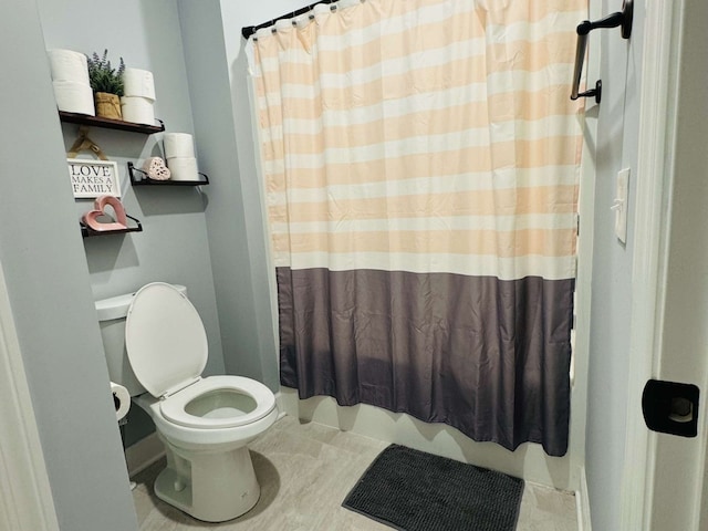 bathroom featuring walk in shower and toilet