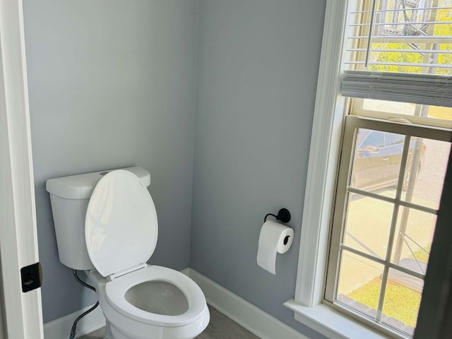 bathroom with plenty of natural light and toilet