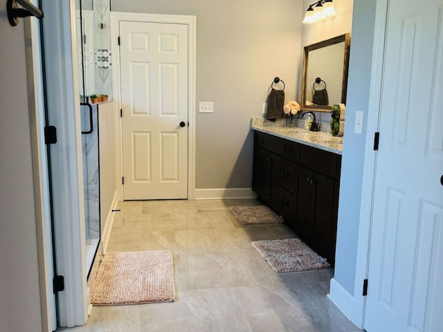 bathroom featuring walk in shower and vanity