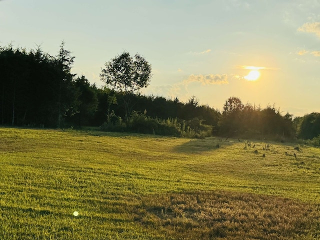 nature at dusk featuring a rural view