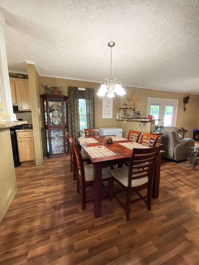 dining area with a notable chandelier, a textured ceiling, and dark wood-type flooring