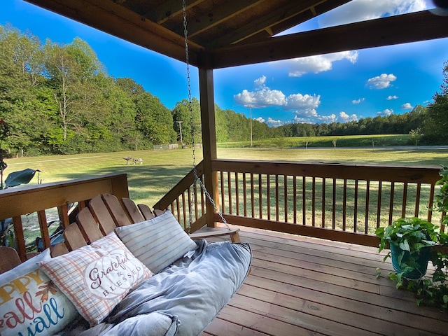 wooden deck with a lawn