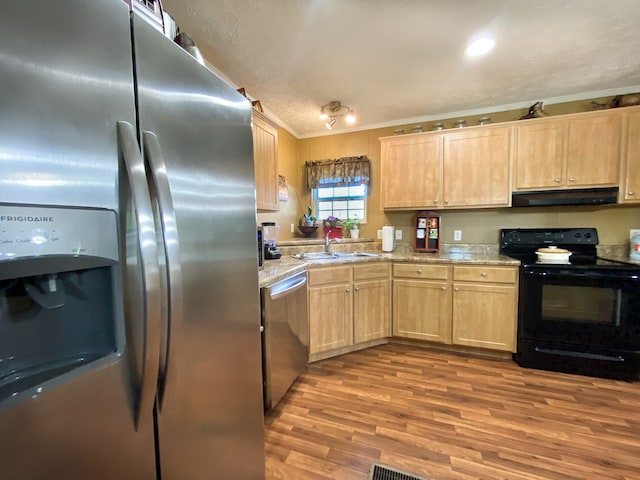 kitchen featuring ventilation hood, appliances with stainless steel finishes, light brown cabinetry, crown molding, and light hardwood / wood-style floors